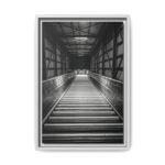 Industrial Automation Art Print Vertical black and white photography of a modern industrial conveyor system with rhythmic rollers and a deep vanishing point.