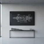 A framed technical art print of a complex mechanical gear assembly on a charcoal gray office wall.